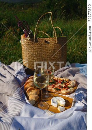 picnic in nature: pizza, cheese, baguette and glasses of wine picnic in nature: pizza, cheese, baguette and glasses of wine 79177200