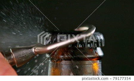 Freeze motion of opening beer bottle. Freeze motion of opening beer bottle. 79177354
