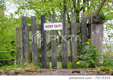The wooden country gate and fence with sign Keep Out. 79178359