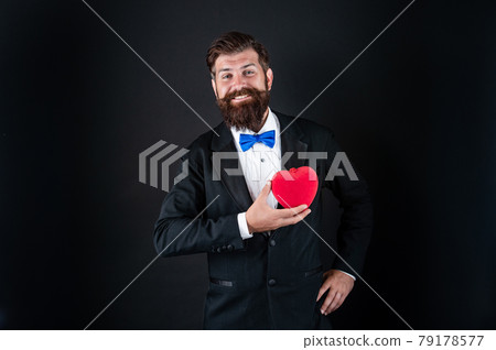 happy tuxedo man with beard hold romantic love heart, happy valentines day 79178577