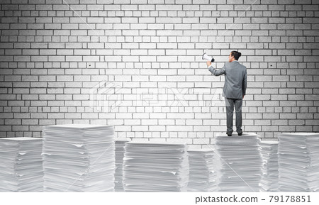 Businessman standing with megaphone. Businessman standing with megaphone. 79178851