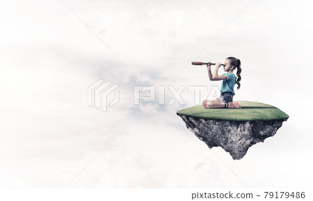 Concept of careless happy childhood with girl looking in spyglas 79179486