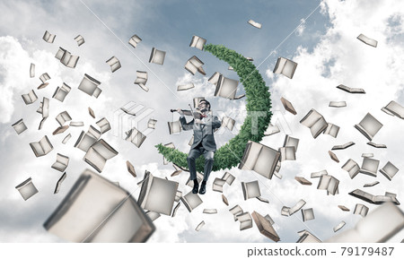 Handsome violinist play his melody and books flying around Handsome violinist play his melody and books flying around 79179487