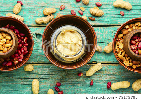 Homemade peanut butter on retro wooden table Homemade peanut butter on retro wooden table 79179783