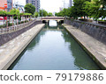 Straight waterway with a bridge 79179886