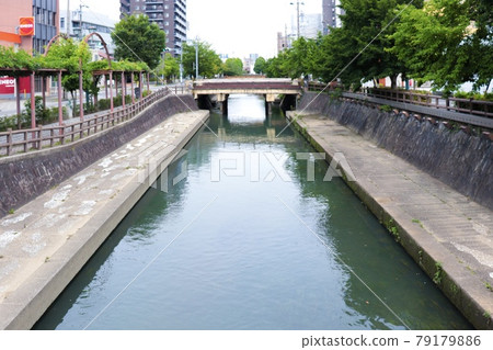 Straight waterway with a bridge Straight waterway with a bridge 79179886
