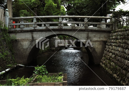 A small stone bridge over the river A small stone bridge over the river 79179887