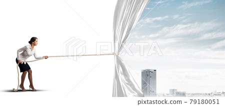 Young woman opening white curtain and presenting modern city landscape Young woman opening white curtain and presenting modern city landscape 79180051