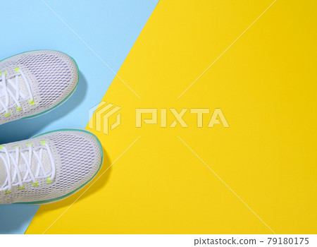 white women's sneakers with laces on a blue yellow background 79180175
