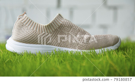 shoes on the grass on the background of a brick wall shoes on the grass on the background of a brick wall 79180857