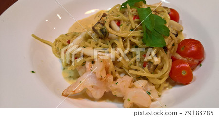 Spaghetti with shrimps, squid, tomatoes, garlic, chili, mussels, cream and parsley. Spaghetti with shrimps, squid, tomatoes, garlic, chili, mussels, cream and parsley. 79183785