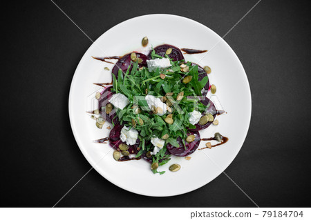 top view of healthy salad with beet, arugula and feta cheese on black background 79184704