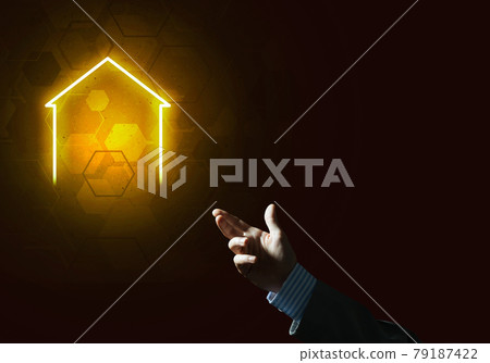Conceptual image with hand pointing at house or main page icon on dark background 79187422