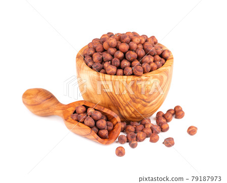 Pile of brown chickpeas in olive bowl and scoop, isolated on white background. Brown chickpea. Garbanzo, bengal gram or chick pea bean. 79187973