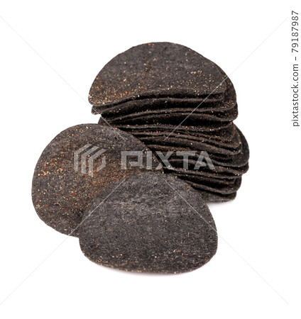 Black potato chips isolated on white background. Black chips with activated charcoal and red pepper. 79187987