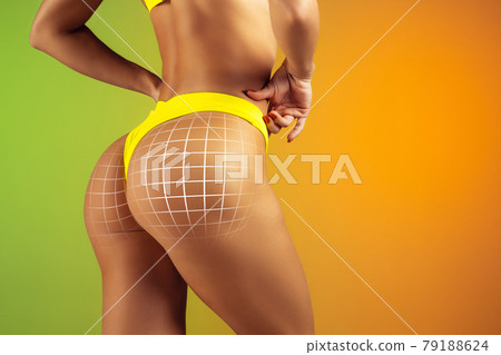 Woman's buttocks with arrows isolated on gradient yellow green background. Back view 79188624