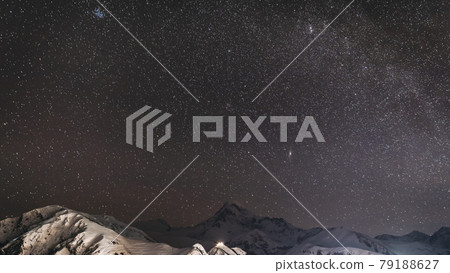 Stepantsminda, Georgia. Winter Night Starry Sky With Glowing Stars Over Peak Of Mount Kazbek Covered With Snow. Beautiful Night Georgian Winter Landscape 79188627