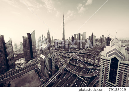 Aerial view of Dubai Downtown skyline, highway roads or street in United Arab Emirates or UAE. Financial district and business area in smart urban city. Skyscraper and high-rise buildings at sunset. Aerial view of Dubai Downtown skyline, highway roads or street in United Arab Emirates or UAE. Financial district and business area in smart urban city. Skyscraper and high-rise buildings at sunset. 79188929