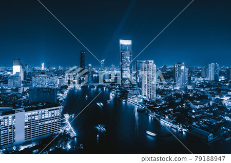 Aerial view of boats and Taksin Bridge with Chao Phraya River, Bangkok Downtown. Thailand. Financial district and business centers in smart urban city. Skyscraper and high-rise buildings at night. Aerial view of boats and Taksin Bridge with Chao Phraya River, Bangkok Downtown. Thailand. Financial district and business centers in smart urban city. Skyscraper and high-rise buildings at night. 79188947