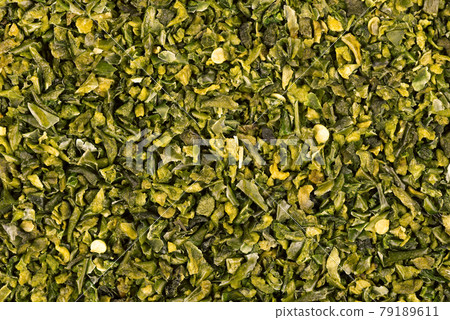 Dried green paprika flakes with seeds background. Chopped jalapeno, habanero or chilli pepper. Spices and herbs. Dried green paprika flakes with seeds background. Chopped jalapeno, habanero or chilli pepper. Spices and herbs. 79189611