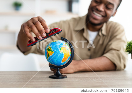 Black Man Playing With Train Model And Globe At Home 79189645