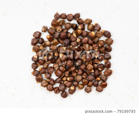 pile of grains of paradise pepper close up on gray 79189785