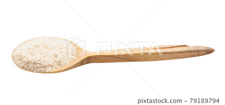 ground asafetida in wooden spoon isolated 79189794