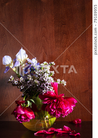 various flowers in vase on dark brown background various flowers in vase on dark brown background 79189955