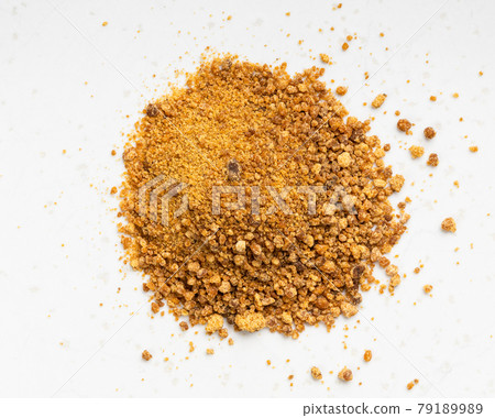 pile of granulated coconut blossom sugar on gray pile of granulated coconut blossom sugar on gray 79189989