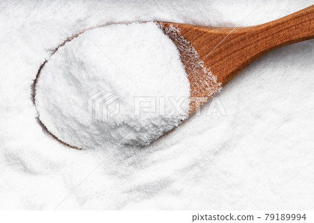 top view of wood spoon with dextrose sugar closeup 79189994