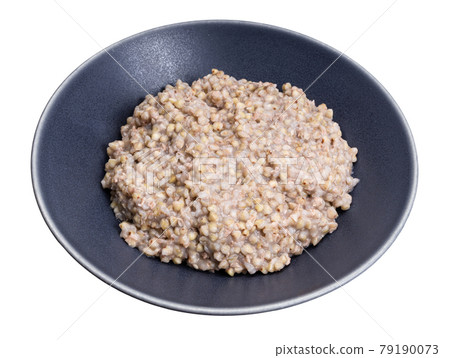 kasha from green buckwheat in gray bowl isolated 79190073
