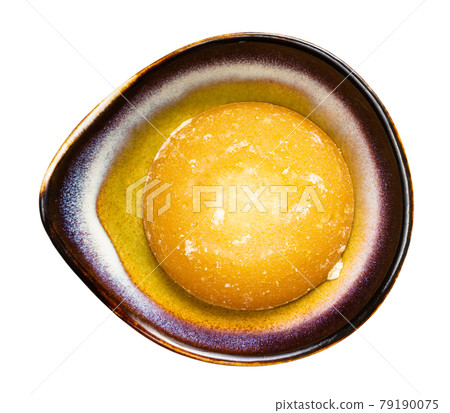 round piece of palm sugar in ceramic bowl isolated round piece of palm sugar in ceramic bowl isolated 79190075