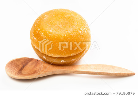 whole round pieces of palm sugar near wooden spoon whole round pieces of palm sugar near wooden spoon 79190079