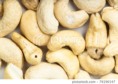 background - many raw cashew seeds 79190147