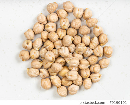 pile of raw dried chickpea seeds close up on gray pile of raw dried chickpea seeds close up on gray 79190191