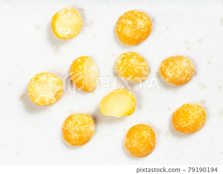 several dried split yellow peas close up on gray several dried split yellow peas close up on gray 79190194