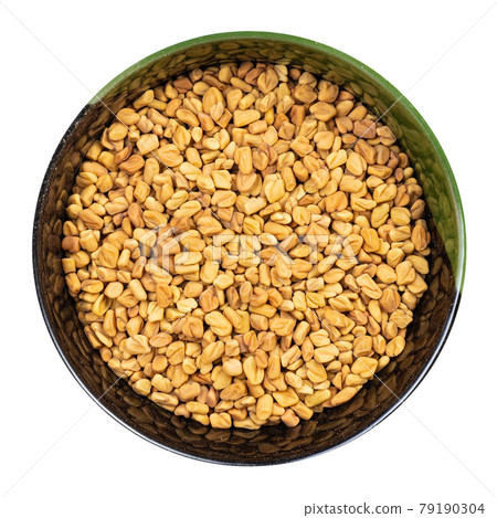 whole fenugreek seeds in round bowl isolated 79190304