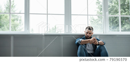 Man feeling sad, tired and worried, suffering depression in mental health, problems and broken heart Man feeling sad, tired and worried, suffering depression in mental health, problems and broken heart 79190370
