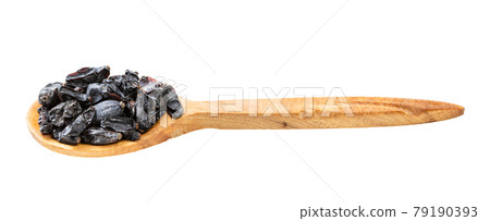 wooden spoon with black barberry fruits isolated 79190393