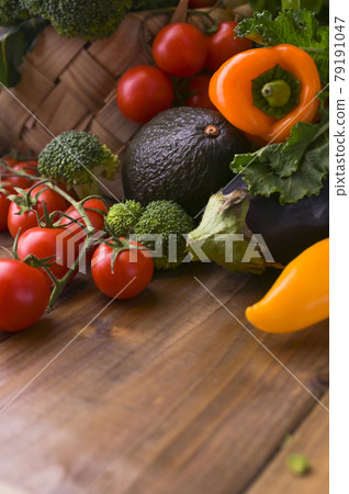 Different vegetables in a basket on a wooden table. Vitamins and health in foods. Healthy food. Different vegetables in a basket on a wooden table. Vitamins and health in foods. Healthy food. 79191047