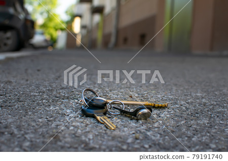 the lost bunch of keys lies on the asphalt road the lost bunch of keys lies on the asphalt road 79191740