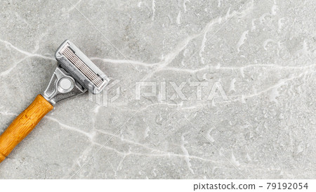Shaving Razor with wooden handle on a grey marble 79192054