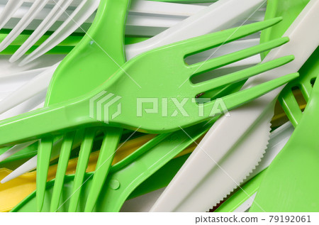 Pile of bright yellow, green and white used plastic kitchenware appliances Pile of bright yellow, green and white used plastic kitchenware appliances 79192061