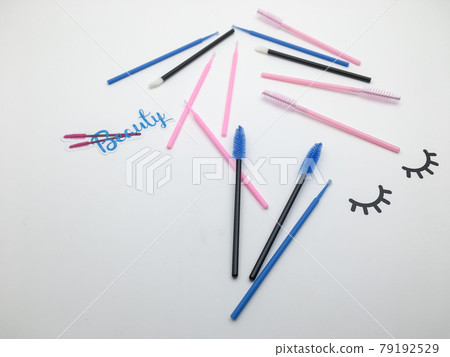 Top view on eyelash extension tools. Flatlay of multi-colored brushes for combing cilia. Top view on eyelash extension tools. Flatlay of multi-colored brushes for combing cilia. 79192529