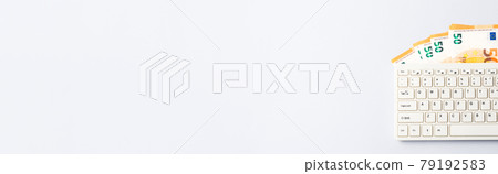 Euro money banknotes under keyboard, online banking, sale of digital info products concept, banner Euro money banknotes under keyboard, online banking, sale of digital info products concept, banner 79192583