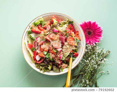 Fresh summer healthy fiber protein vitamin salad in bowl with strawberries, lettuce, tuna, tomatoes Fresh summer healthy fiber protein vitamin salad in bowl with strawberries, lettuce, tuna, tomatoes 79192602