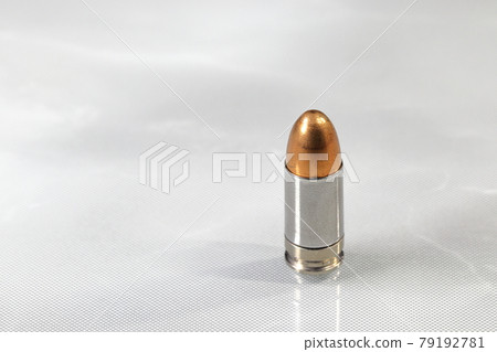 close up bullet 9mm parabellum FMJ (Full Metal Jacket ) on reflection surface. close up bullet 9mm parabellum FMJ (Full Metal Jacket ) on reflection surface. 79192781