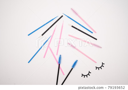 Top view on eyelash extension tools. Flatlay of multi-colored brushes for combing cilia. 79193652