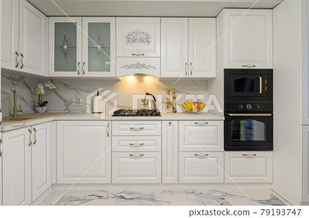White kitchen in classic style, front view 79193747