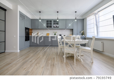 Trendy grey and white modern kitchen furniture in studio apartment Trendy grey and white modern kitchen furniture in studio apartment 79193749